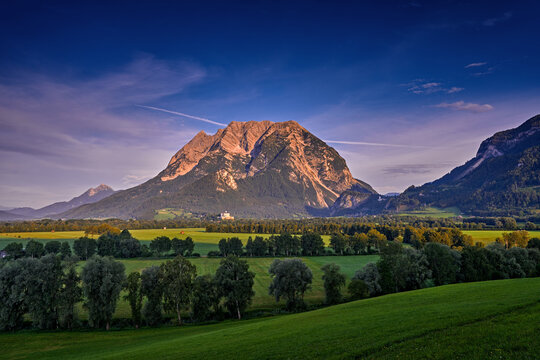Mountain sunrise. Grimming (2351m)  peak in the Dachstein Mountains of Austria, ultra-prominent mountains of Alps. Morning in Europe. Hill with first pink sun ray on the rock. Summer Austria.