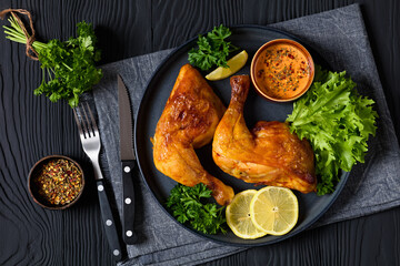 fried chicken legs with lettuce, lemon on plate