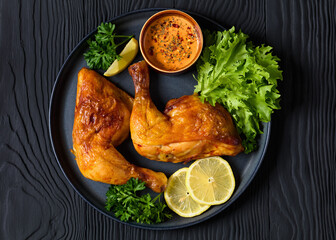 fried chicken legs with lettuce, lemon on plate