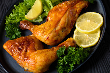 fried chicken legs with lettuce, lemon on plate