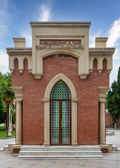 Obraz premium The Javad Xan Mausoleum in Ganja, Azerbaijan, showcases intricate architectural details, framed by lush gardens and a bright blue sky