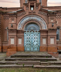 A stunning view of the entrance of Alexander Nevsky Church showcases decorated blue metal door, and...