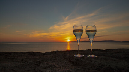 two glasses of prosecco on the sunset of the Alghero ramparts