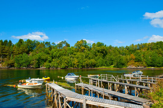 Beautiful landscape of wooden pier and boats at Buena Kai, Lysekloster, Norway