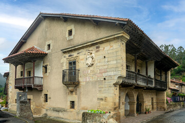 Typical pasiega house from Cantabria, Spain, in the town of Barcenillas with heraldic shield and wooden balconies