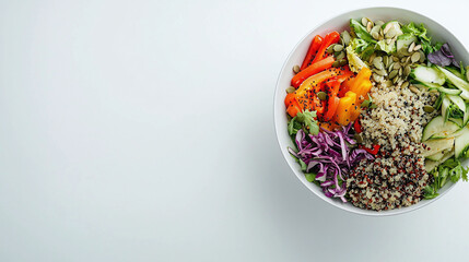 a fresh salad bowl filled with colorful vegetables, quinoa, and seeds, placed on a clean, white surface.