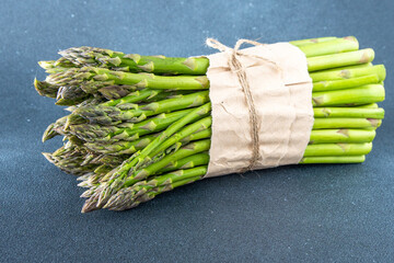 Bunch of green asparagus. Fresh spring vegetable on black background