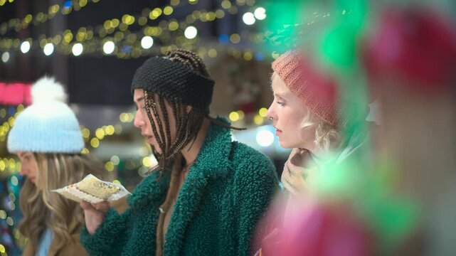 Friends discussing directions on christmas market map in slow motion