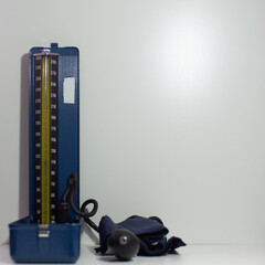 traditional blood pressure monitor on a table and white background