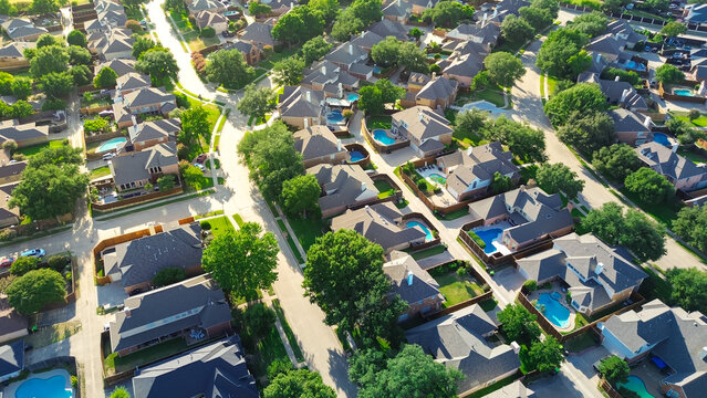 Tree lined residential street in upscale suburban Wentworth Estates neighborhood in West Plano, Texas, two-story single-family homes, swimming pool, suburbs Dallas Fort Worth metroplex, aerial