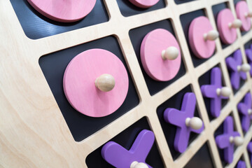 Close-up of XO, wooden board, XO game, psychology, small wooden toy, pastel colors
