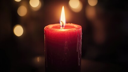 A red candle burning softly in a dark room, creating a warm and intimate atmosphere
