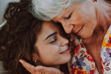 Beautiful grandmother and granddaughter together at home - Cheerful granma and nephew spending...