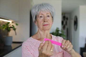 Lady doing her nails at home 