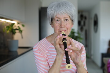 Senior woman playing the flute