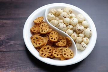 Crispy lotus stem chips and roasted makhana, perfectly spiced and golden brown, offer a delightful crunch and unique flavor. Ideal for healthy snacking or as a gourmet appetizer. kurkuri Kamal kakdi. 