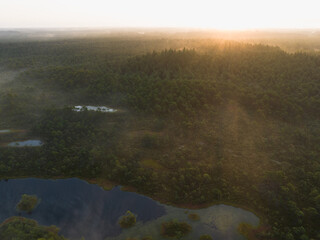 Nature of Estonia, Seli swamp at sunrise, fog from lakes, aerial drone view.