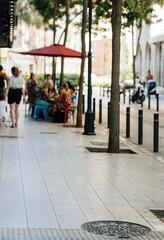 A defocused view of a street in Palma de Mallorca, capturing the soft and blurred ambiance of the area, with hints of architecture and local life in the background