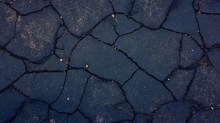 Obraz premium A close up of a cracked asphalt surface