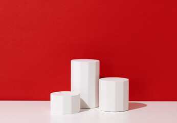 Christmas theme product presentation background made with three pedestals on red.