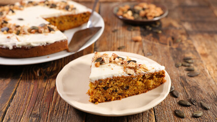 piece of traditional pumpkin pie on wood background