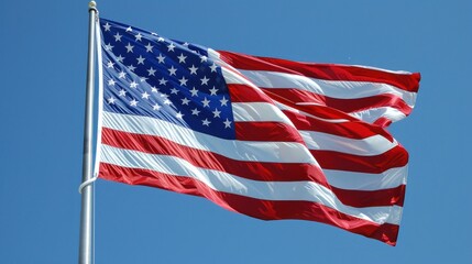 Obraz premium American flag blowing in the wind, clear sky