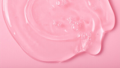 Transparent hyaluronic acid gel texture on pastel pink backdrop. Serum for skincare. Beauty concept.