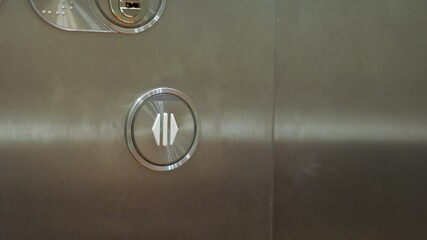 Close up of male forefinger pressing on the open door button in elevator (lift). Mechanical engineering concept
