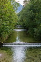 Obraz premium alpine river stepped waterfall in summer