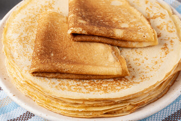 Stack of traditional russian pancakes blini on gray background. Homemade russian thin pancakes blini. Russian food, russian kitchen