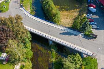 Reinforced concrete road bridge over the river. Close-up during sunny day in summer. Aerial view on...