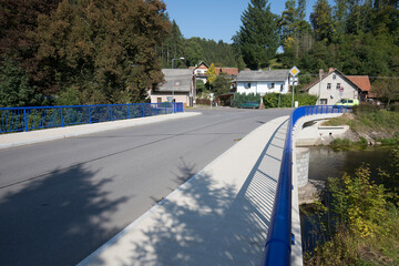 Reinforced concrete road bridge over the river. Close-up during sunny day in summer. Aerial view on...