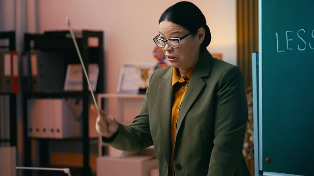 Comically irritated Asian teacher scolding students during a test, strict woman