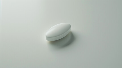A lone medical pill centered on a smooth, white surface