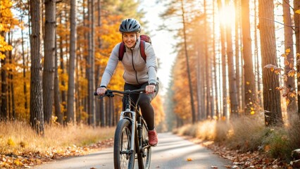 Fototapeta premium Woman Biking in Autumn Forest at Sunrise