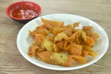 crispy fried dumpling paste stuffed chop pork dipping sweet chili sauce on plate
