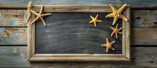 Blank blackboard and starfish on a wooden surface Summer vacation theme. Copy space image. Place for adding text and design