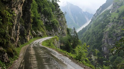narrow mountain road with sheer drops on one side, emphasizing the thrill and danger of the drive.