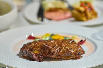 a piece of juicy steak on a white plate