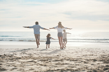 Beach, run and airplane with family back, play and adventure freedom by ocean on blue sky. Flying, game and children running with parents in Miami shore for holiday travel, trip and summer vacation