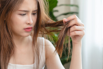 Serious, worried asian young woman, girl holding, show damaged loss hair, problem after brushing,...