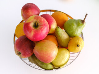 fruit basket with a variety of organic fruits on white background