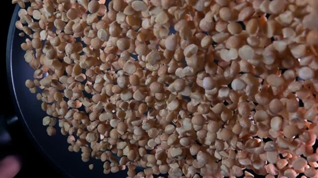 Super slow motion footage of peas flying from a frying pan. Filmed on a high-speed film camera, 1000 frames per second