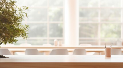 A cozy workspace showcases a countertop adorned with a refreshing smoothie, complemented by lush greenery. The room is filled with natural daylight, promoting a calm vibe