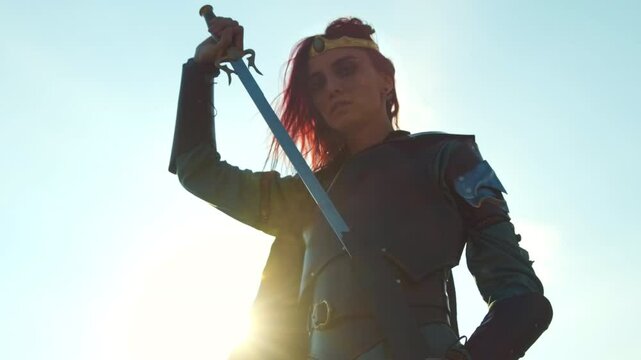 A medieval warrior woman sheaths her sword, the rays of the sun accentuating her presence and highlighting her strength.