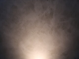 Light shines on the dark gray wall. Interior concept.