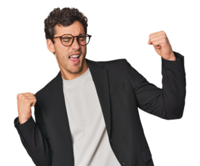 Young Hispanic businessman raising fist after a victory, winner concept.