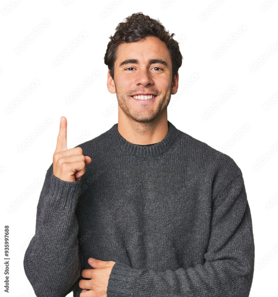 Wall mural Young Hispanic man in studio showing number one with finger.