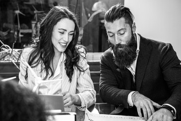 Business coworkers working together in a modern office - Startup coworkers collaboration and cooperation concept - Focus on hipster businessman - Black and white editing