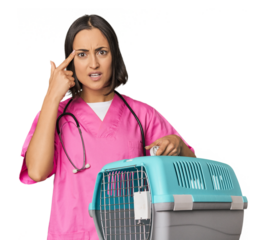 Young Caucasian female vet holding cage showing a disappointment gesture with forefinger.